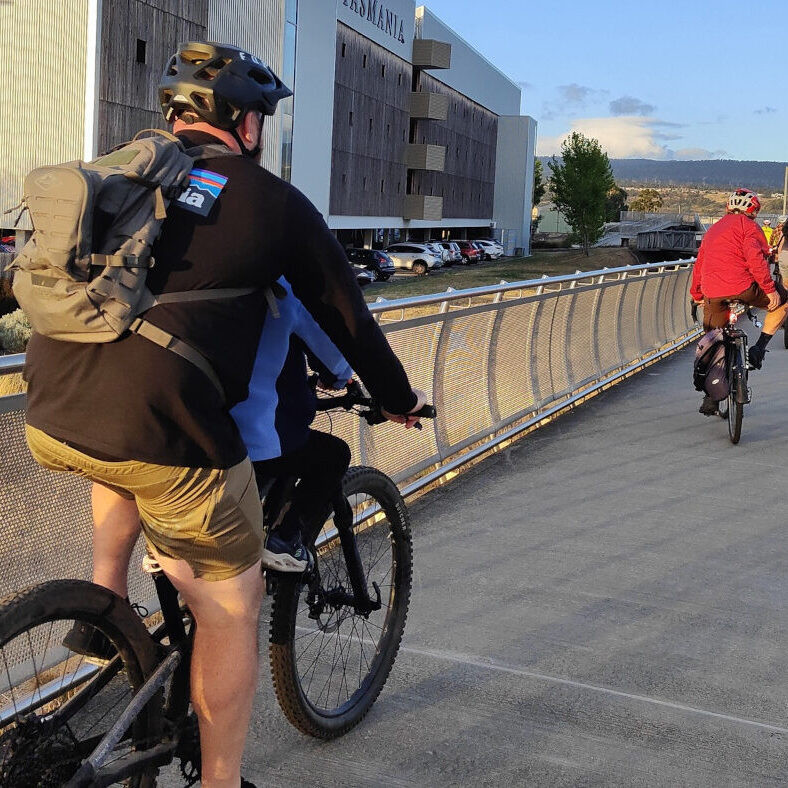 People cycling on the levy bank.